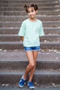 Nine-year-old girl standing on the steps outdoors