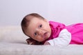 Adorable one month old baby girl in pink dress lies on a soft blanket Royalty Free Stock Photo