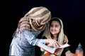 Adorable Pakistani girl with beautiful eyes wear hijab, learning Quran book with mother, Muslim family, daughter and mom read holy Royalty Free Stock Photo