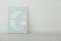 Adorable picture of moon on floor near wall, space for text. Children`s room interior element