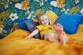 Adorable playful little girl sitting on bed Royalty Free Stock Photo