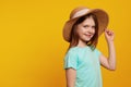 Adorable positive active girl kid wearing blue t shirt and stylish hat