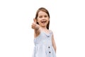 Adorable positive child girl smiling and shows thumbs up on white background in studio. Kids lifestyle and having fun Royalty Free Stock Photo