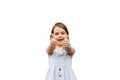 Adorable positive child girl smiling and shows thumbs up on white background in studio. Kids lifestyle and having fun Royalty Free Stock Photo