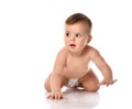 Adorable positive little baby girl infant in diaper try to creep on floor smiling and looking aside on white