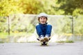 Adorable preschool child, skateboarding on the street