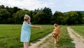Adorable preschool girl playing with her cute pet dog golden retriever Royalty Free Stock Photo