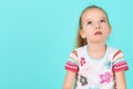 Adorable preschooler girl deep in thoughts, looking up. Concentration, decision, vision concept. Royalty Free Stock Photo