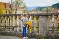 Adorable preschooler girl enjoying nice and sunny autumn day outdoors