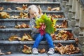 Adorable preschooler girl enjoying nice and sunny autumn day outdoors