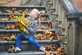 Adorable preschooler girl enjoying nice and sunny autumn day outdoors