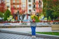 Adorable preschooler girl enjoying nice and sunny autumn day outdoors