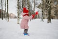 Adorable preschooler girl having fun in beautiful winter park on a snowy cold winter day Royalty Free Stock Photo