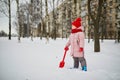 Adorable preschooler girl having fun in beautiful winter park on a snowy cold winter day Royalty Free Stock Photo