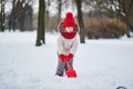 Adorable preschooler girl having fun in beautiful winter park on a snowy cold winter day Royalty Free Stock Photo