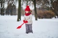 Adorable preschooler girl having fun in beautiful winter park on a snowy cold winter day Royalty Free Stock Photo