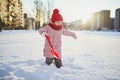 Adorable preschooler girl having fun in beautiful winter park on a snowy cold winter day Royalty Free Stock Photo