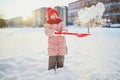 Adorable preschooler girl having fun in beautiful winter park on a snowy cold winter day Royalty Free Stock Photo