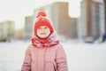 Adorable preschooler girl having fun in beautiful winter park on a snowy cold winter day Royalty Free Stock Photo