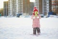 Adorable preschooler girl having fun in beautiful winter park on a snowy cold winter day Royalty Free Stock Photo