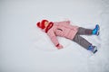 Adorable preschooler girl having fun in beautiful winter park on a snowy cold winter day Royalty Free Stock Photo