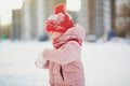 Adorable preschooler girl having fun in beautiful winter park on a snowy cold winter day Royalty Free Stock Photo