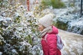 Adorable preschooler girl having fun in beautiful winter park on a snowy cold winter day Royalty Free Stock Photo