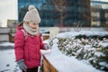 Adorable preschooler girl having fun in beautiful winter park on a snowy cold winter day Royalty Free Stock Photo