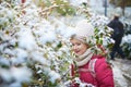 Adorable preschooler girl having fun in beautiful winter park on a snowy cold winter day Royalty Free Stock Photo