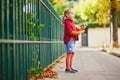 Adorable preschooler girl having fun on a street on a fall day