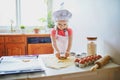 Adorable preschooler girl making cookies