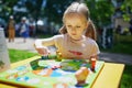 Adorable preschooler girl playing board game