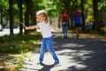 Adorable preschooler girl playing with a stick