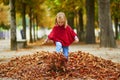 Adorable preschooler girl walking in Tuileries garden in Paris, on a fall day Royalty Free Stock Photo