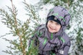 Adorable preschooler in winter wear sit amoung snow and play wit