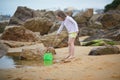 Adorable preshooler girl playing with scoop net on the beach at Atlantic coast of Brittany, France