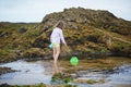 Adorable preshooler girl playing with scoop net on the beach at Atlantic coast of Brittany, France