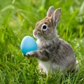 Adorable rabbit holds blue egg, epitomizing Easter holiday charm