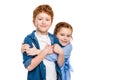 adorable redhead siblings hugging and smiling at camera