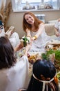 Adorable redhead woman taking wrapped gift box celebrating birthday in modern hippie bohemian style