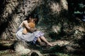 Adorable sad girl with teddy bear in park, Royalty Free Stock Photo