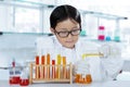 Adorable schoolboy experimenting chemical liquid