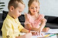 adorable siblings drawing with colored pencils