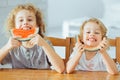 Adorable siblings eating watermelon