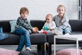 adorable siblings and infant baby sitting together