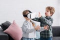 adorable siblings playing with virtual reality headset