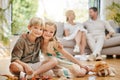 Adorable sister and brother hugging while sitting together. Little girl and boy looking happy while playing together at Royalty Free Stock Photo