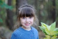 Adorable small girl in the autumn forest