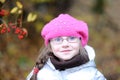 Adorable small girl in bright pink hat