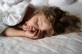 Adorable small kids rest asleep enjoy good healthy peaceful sleep or nap. Six years old Kid sleeping in bed.